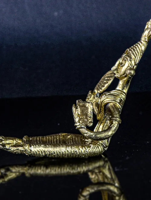 Bengal Dokra Adivasi girl reading book with hand fan in hand