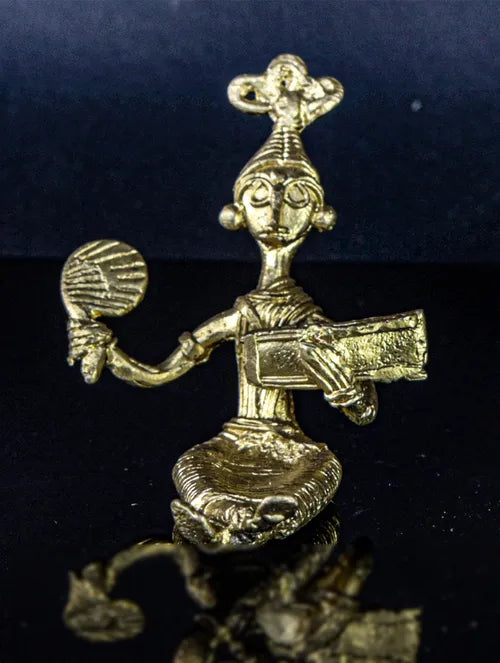 Bengal Dokra Adivasi girl reading book with hand fan in hand