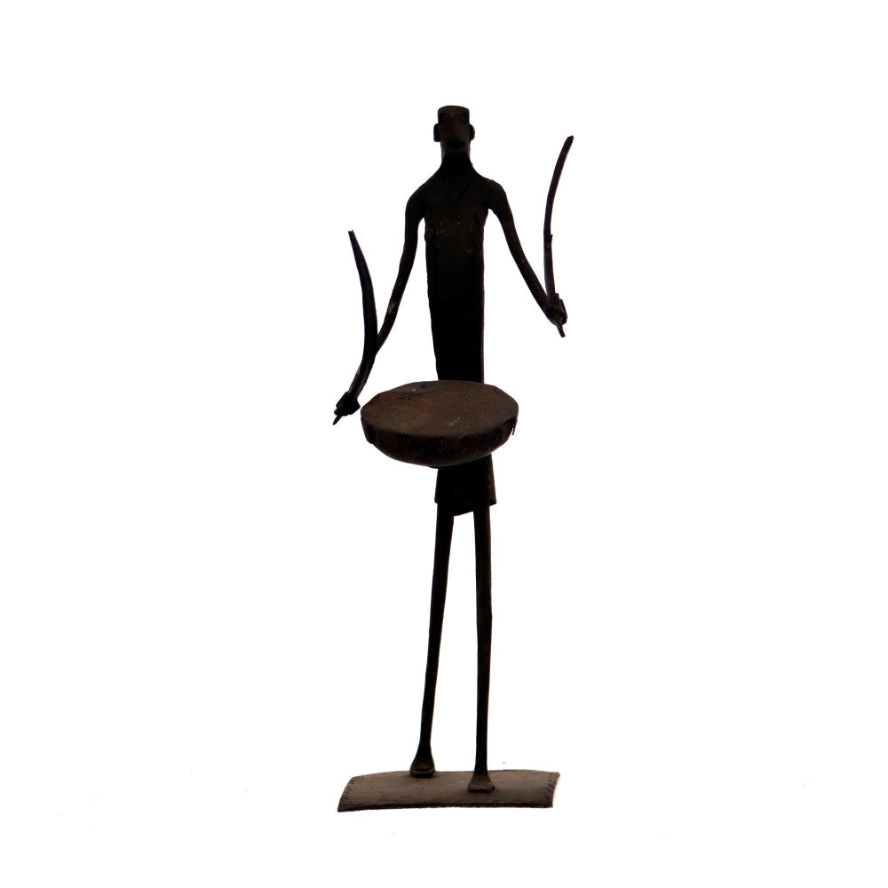 Standing Maadia beating dhol