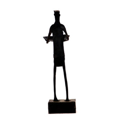 Standing Maadia holding a candle stand in hand