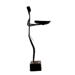 Standing Maadia holding a candle stand in hand